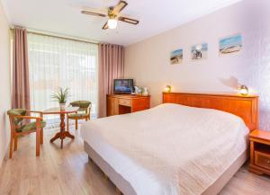 a bedroom with a bed and a desk and a table at Rades in Władysławowo +62 photos