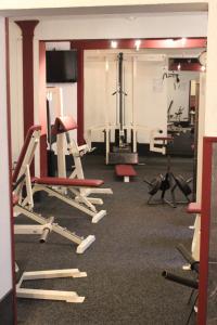 a gym with a bunch of exercise equipment in it at Haus Abbi, Ferienwohnung mit Schwimmbad in Hage