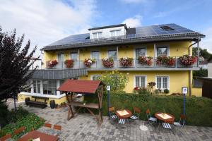 a yellow house with solar panels on top of it at Hotel Hecht Garni in Ingolstadt