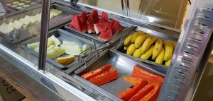 a bunch of different fruits and vegetables in trays at Lisboa Palace Hotel in Alta Floresta