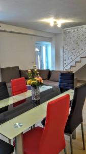 a living room with a table and colorful chairs at Holiday apartments Maslina Paho in Babino Polje