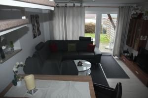 a living room with a couch and a table at Ferienhaus LIVI in Zandt