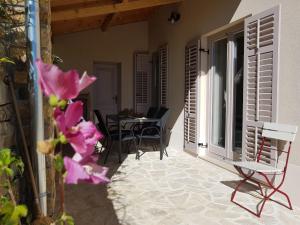 a patio with chairs and a table on a balcony at Vila Flora in Sečovlje +32 photos