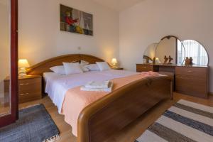 a bedroom with a large bed and a large mirror at Apartman Laura in Selce