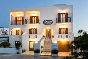 a facade of a white building with an arch at Panos Luxury Studios in Parikia