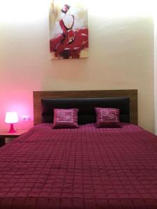 a bedroom with a bed with purple sheets and pillows at Sweet Apartment New Gudauri 3 in Gudauri