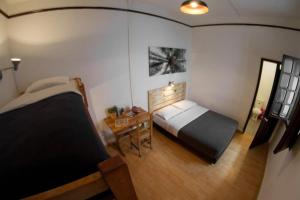 a bedroom with a bed and a table in it at Explora Hostels in Bogotá