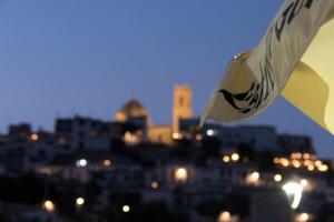 a view of a city at night with a flag at Gran H La Marina in Altea