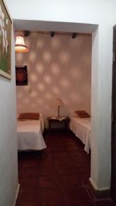 a hallway with two beds in a room at Las Tinajas de San Carlos in San Carlos