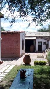 a patio with a large vase in the yard at Las Tinajas de San Carlos in San Carlos