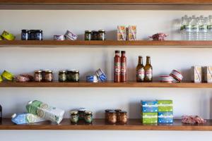 a shelf filled with lots of bottles and boxes at Volcanic Charming House in Ribeira Grande