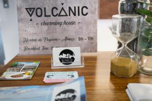 a table with a clock and a sign on it at Volcanic Charming House in Ribeira Grande