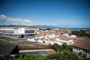 a view of a city with buildings and the ocean at Volcanic Charming House in Ribeira Grande