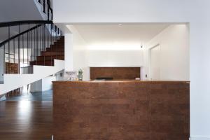a kitchen with a wooden counter and a staircase at Volcanic Charming House in Ribeira Grande