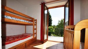 a bedroom with two bunk beds and a large window at Casa Paradiso in Tremosine Sul Garda