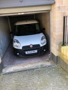 a small white car parked in a garage at Edinburgh Old Town in Edinburgh