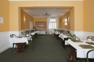 a dining room with white tables and chairs at All Seasons Lodge Hotel in Great Yarmouth +15 photos