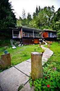 a house in the middle of a yard at J Residence in Kundasang