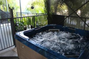 a hot tub filled with water on a balcony at Gecko Guest House in Cooktown