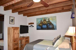 a bedroom with a bed and a flat screen tv at Hotel Ana Catalina and Suites in San Miguel de Allende