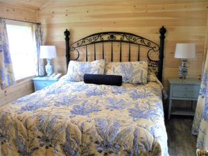 a bedroom with a bed with a laptop on it at Colonial Gables Oceanfront Village in Belfast