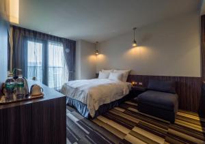 Postel nebo postele na pokoji v ubytování Watermark Hotel Kaohsiung Main Station