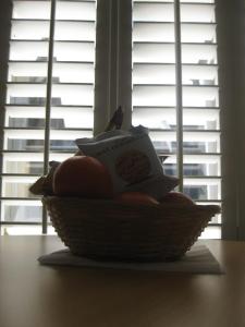 a basket filled with books on a table with a window at Aquarium Guest House in Brighton & Hove