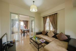 a living room with a couch and a table at City View Apartment in Phnom Penh