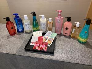 a counter with a tray of soap and bottles of detergents at Hotel Be-zen shimanouchi in Osaka