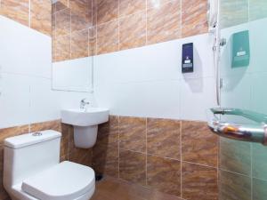 a bathroom with a toilet and a sink at Hotel Rosmerah in Ayer Keroh +13 photos