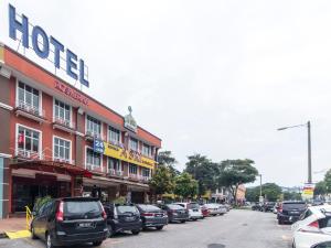 a row of cars parked in front of a hotel at Hotel Rosmerah in Ayer Keroh