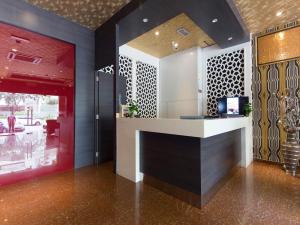a lobby with a counter in a building at Hotel Rosmerah in Ayer Keroh