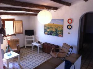 a living room with a couch and a tv at La Fattoria in Sciacca