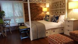 a bedroom with a bed and a dresser at Ballina Palms Boutique Motel in Ballina