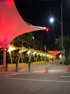 a street at night with a red traffic light at Luxury Homestay at Puteri Harbour with Seaview in Nusajaya