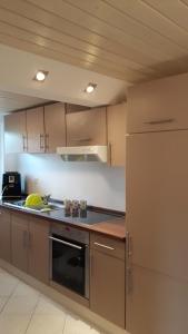 a kitchen with a refrigerator and a stove top oven at Super schöne Fewo in Aalen
