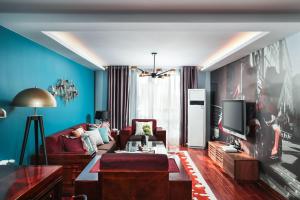 a living room with a couch and a tv at NanJing GuLou·Lion Bridge· Locals Apartment 00152470 in Nanjing