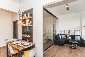 a dining room and living room with a table and chairs at Apartment Mille in Rijeka