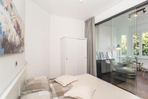 a bedroom with a bed and a living room at Apartment Mille in Rijeka