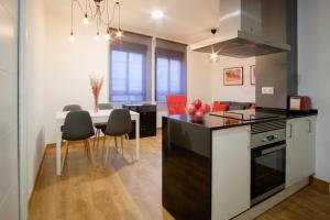 a kitchen and living room with a table and chairs at Cigarreras Lovely Loft in Alicante