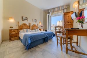 Postel nebo postele na pokoji v ubytování Hotel La Española