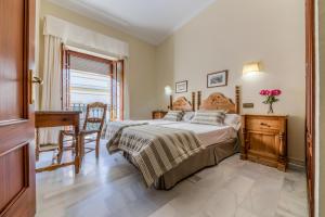 Postel nebo postele na pokoji v ubytování Hotel La Española