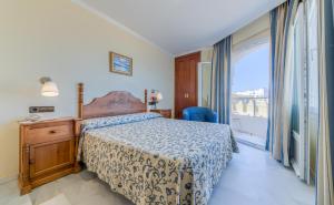 Postel nebo postele na pokoji v ubytování Hotel La Española