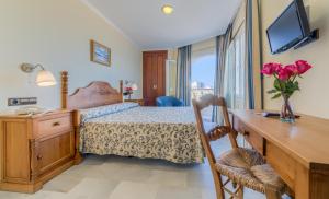 Postel nebo postele na pokoji v ubytování Hotel La Española