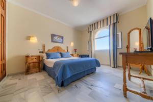 Postel nebo postele na pokoji v ubytování Hotel La Española