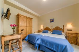 Postel nebo postele na pokoji v ubytování Hotel La Española