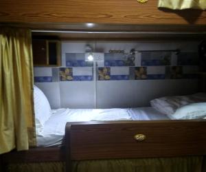 a bedroom with two beds and a mirror at Ahlan Dormitory in Mumbai