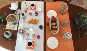 a table with plates of food and coffee on it at Kericouette et Délices in Le Vieux-Bourg