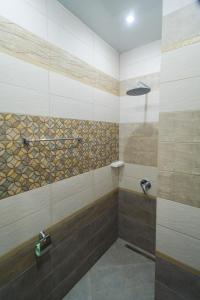 a bathroom with a shower with a glass door at Motel Uyut in Krutinka