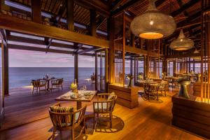 a restaurant with a view of the ocean at Kudadoo Maldives Private Island – Luxury All inclusive in Lhaviyani Atoll